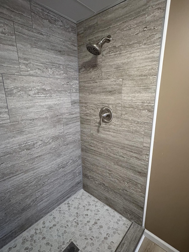 bathroom with tiled shower