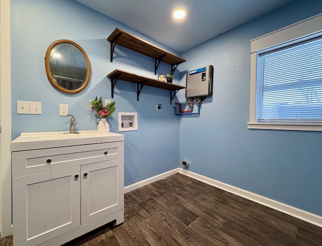 laundry area with hookup for an electric dryer, dark hardwood / wood-style floors, hookup for a washing machine, cabinets, and sink