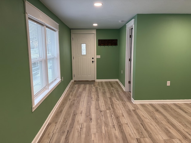 foyer entrance with light hardwood / wood-style floors