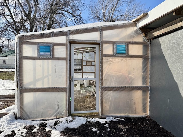 view of snow covered property entrance