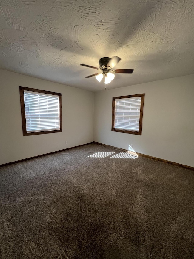 carpeted empty room with a textured ceiling and ceiling fan