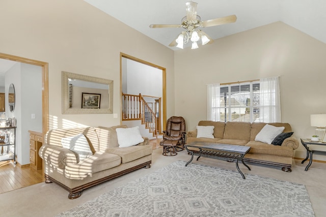 carpeted living room featuring ceiling fan and high vaulted ceiling