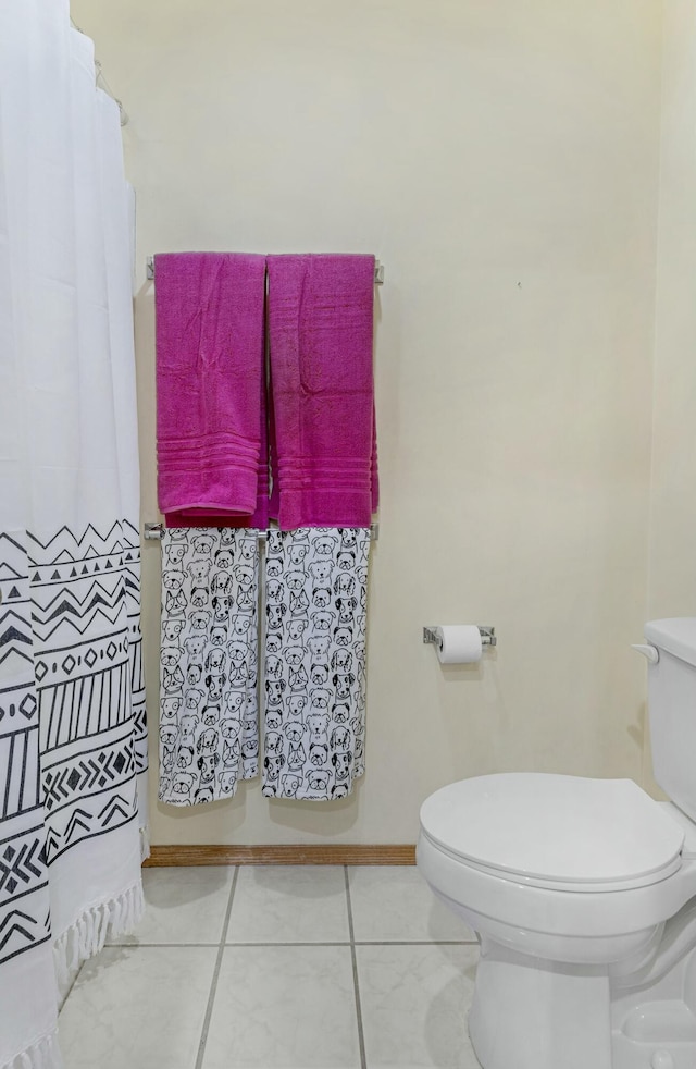 bathroom with toilet and tile patterned floors