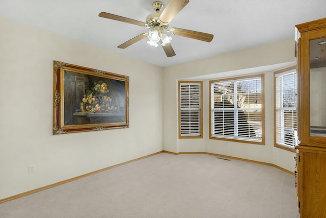 empty room featuring light carpet and ceiling fan