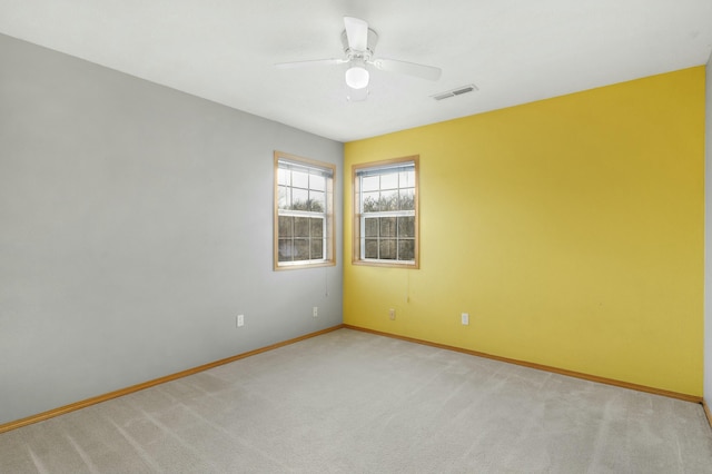 unfurnished room with ceiling fan and light colored carpet