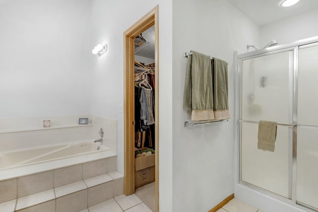 bathroom featuring plus walk in shower and tile patterned flooring