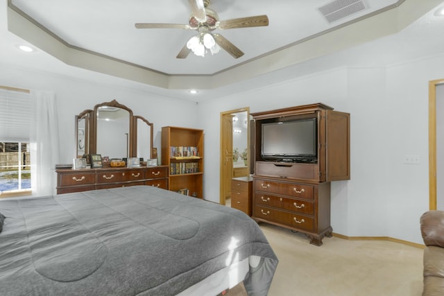 carpeted bedroom featuring ceiling fan and a raised ceiling