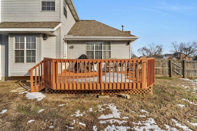 snow covered house featuring a wooden deck