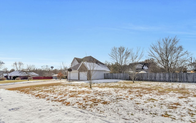 view of snow covered exterior featuring a garage