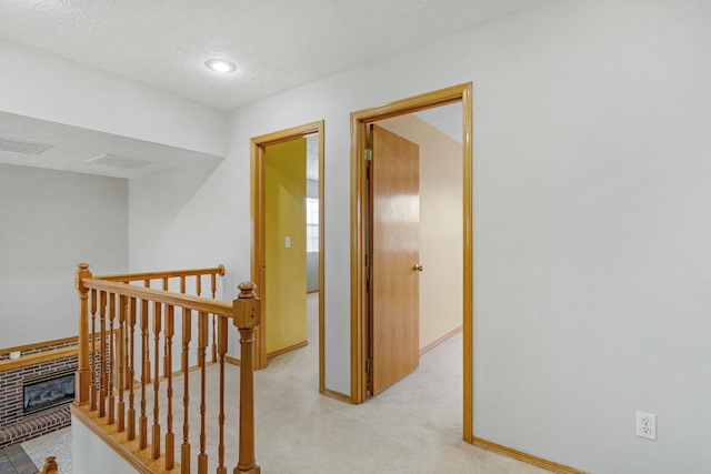 hallway with a textured ceiling