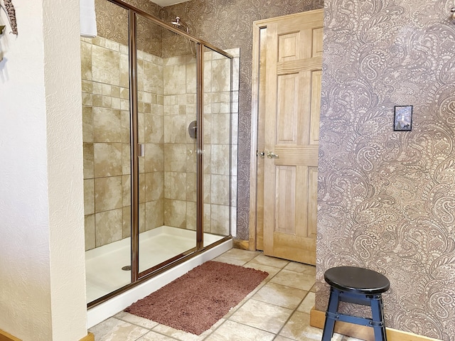 bathroom with tile patterned flooring and a shower with door