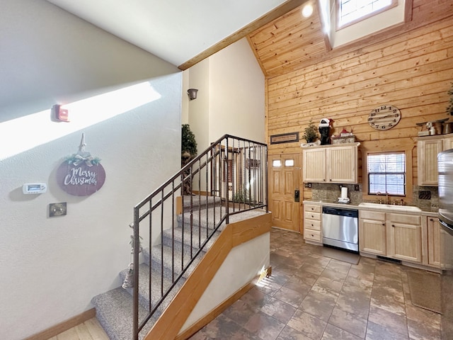 kitchen with light brown cabinets, tasteful backsplash, sink, high vaulted ceiling, and stainless steel dishwasher