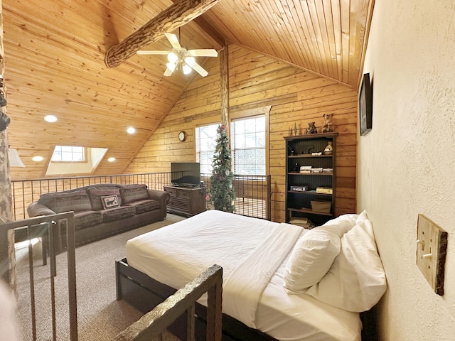 carpeted bedroom featuring ceiling fan, wood walls, beamed ceiling, a skylight, and wood ceiling