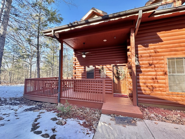 snow covered deck featuring a porch