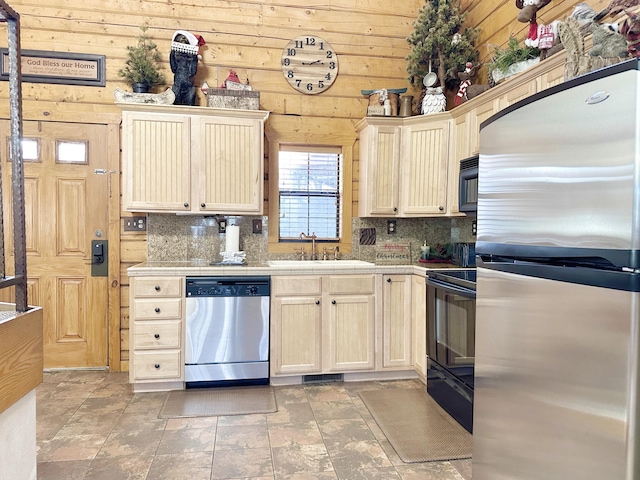 kitchen featuring sink, black appliances, and tasteful backsplash