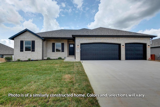 view of front of house with a front lawn and a garage