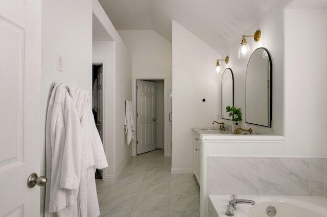 bathroom with tiled bath and vanity