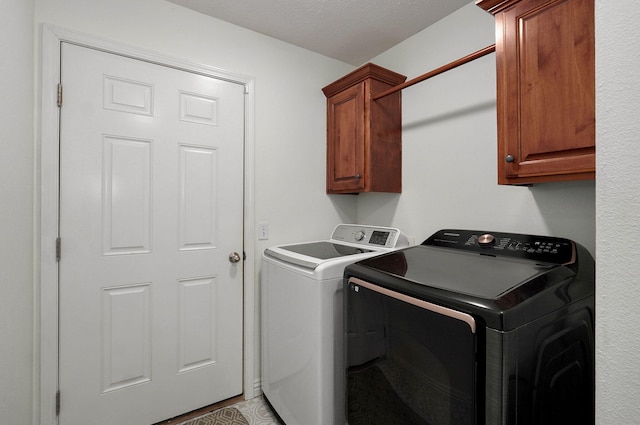 washroom with cabinets and separate washer and dryer