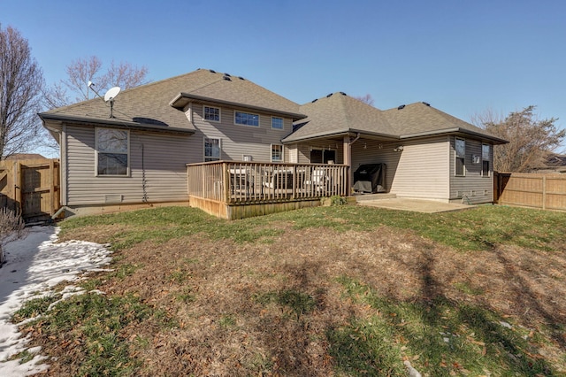 back of property featuring a patio area, a deck, and a yard