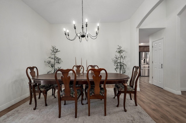 dining room featuring an inviting chandelier and hardwood / wood-style flooring