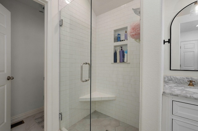 bathroom featuring an enclosed shower and vanity