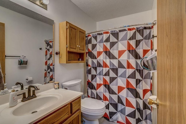 bathroom featuring a textured ceiling, toilet, a shower with curtain, and vanity