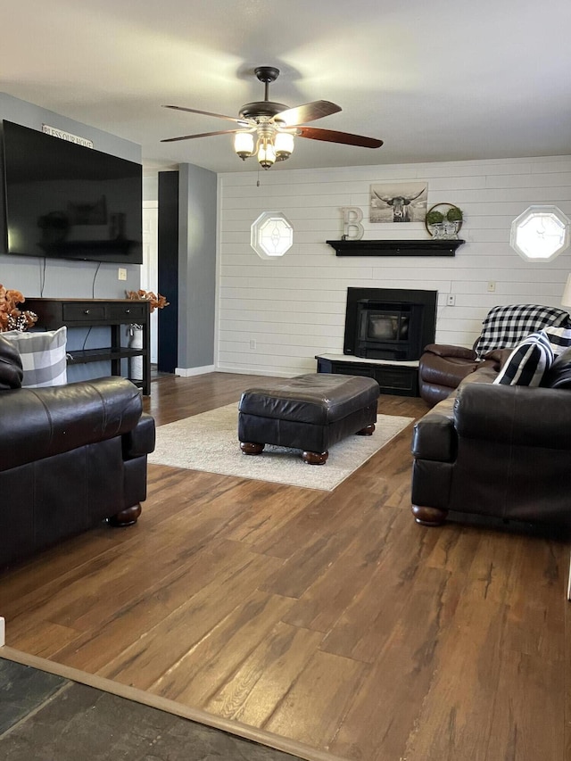 living room with ceiling fan and dark hardwood / wood-style flooring