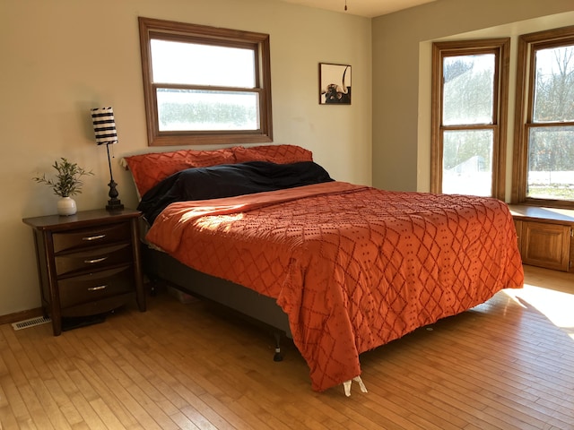 bedroom featuring light hardwood / wood-style floors and multiple windows