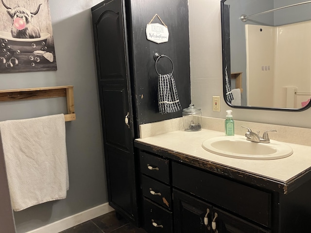 bathroom featuring a shower, vanity, and tile patterned flooring