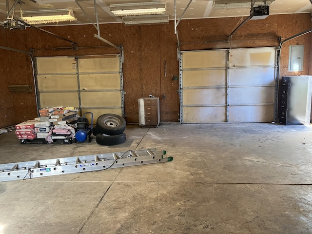 garage featuring a garage door opener and electric panel