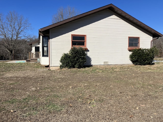 view of side of home featuring a lawn