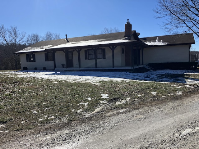 back of house featuring a porch