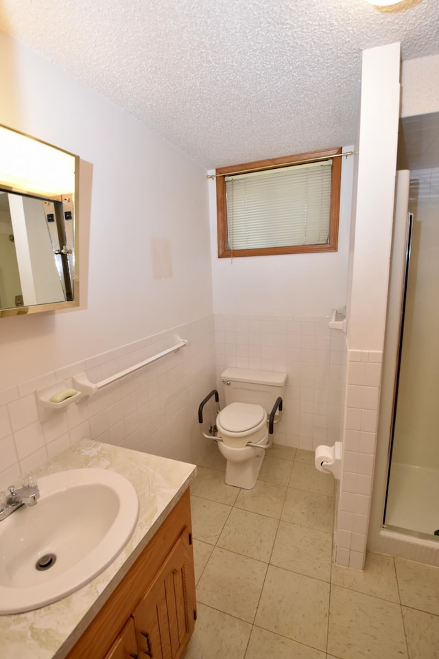 bathroom with toilet, tile patterned flooring, a textured ceiling, and vanity