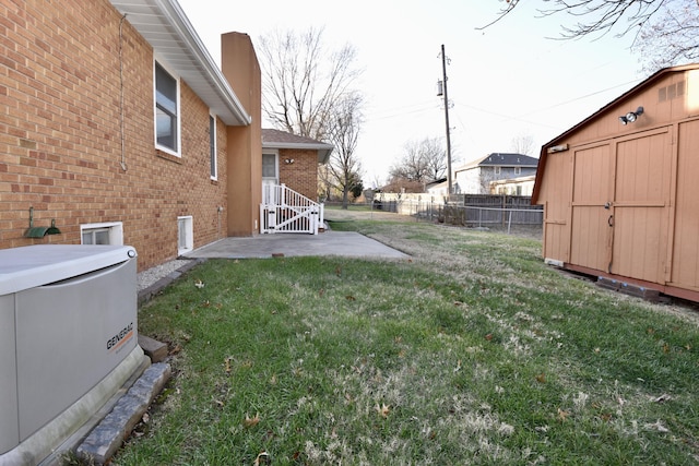 view of yard with a patio, a hot tub, a storage shed, fence, and an outdoor structure