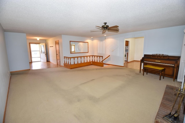 interior space with carpet, a ceiling fan, and a textured ceiling