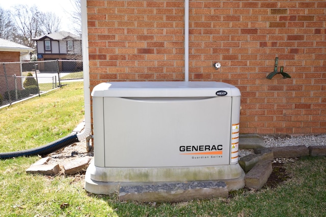 exterior details featuring fence, a power unit, and brick siding