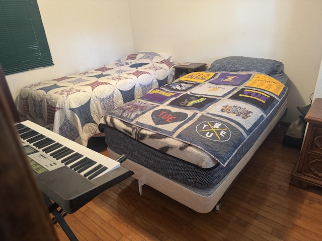 bedroom with dark wood-type flooring