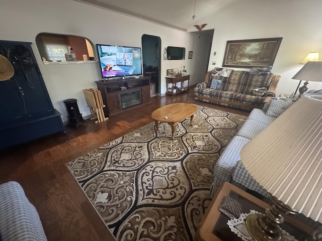 living room with dark hardwood / wood-style flooring and vaulted ceiling