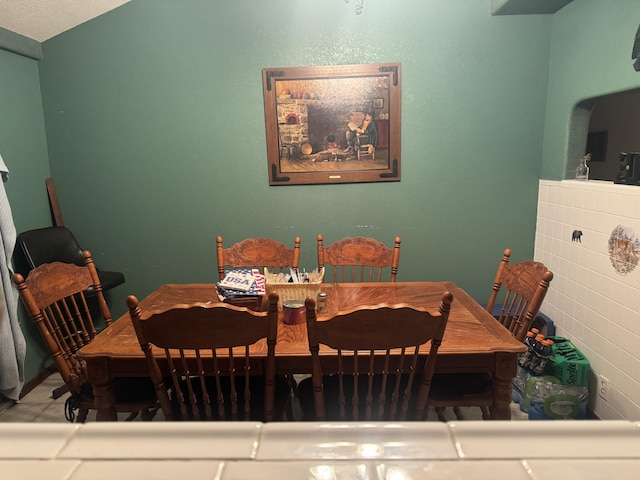 dining area featuring a textured ceiling