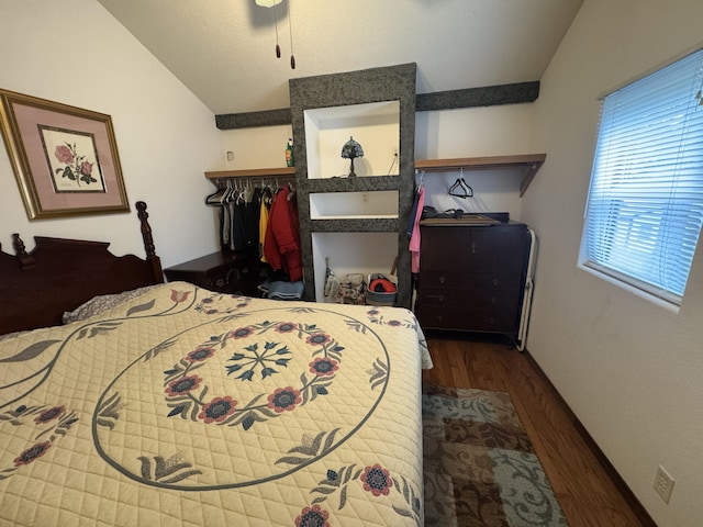 bedroom with dark hardwood / wood-style flooring and vaulted ceiling