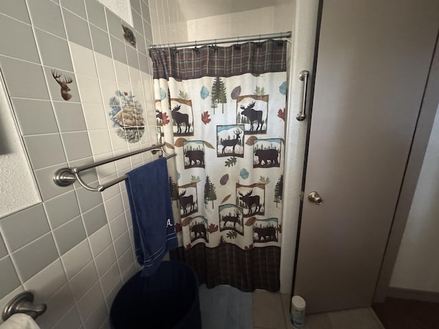 bathroom with toilet and a shower with shower curtain