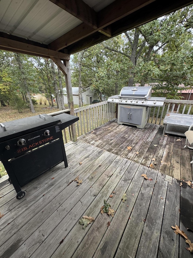 wooden deck featuring a grill