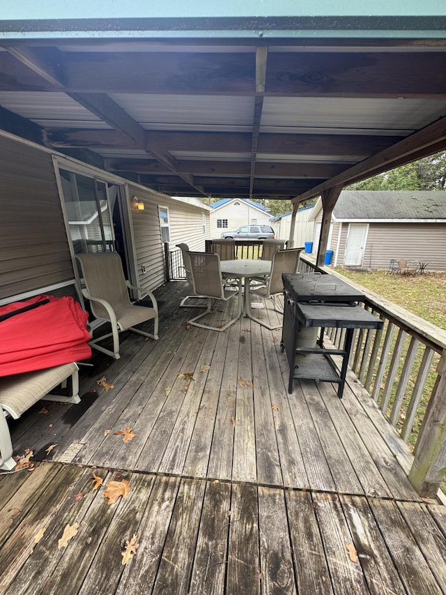 wooden terrace with a storage shed