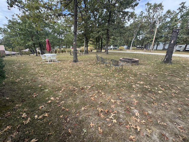 view of yard with an outdoor fire pit