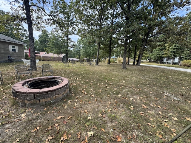 view of yard with an outdoor fire pit