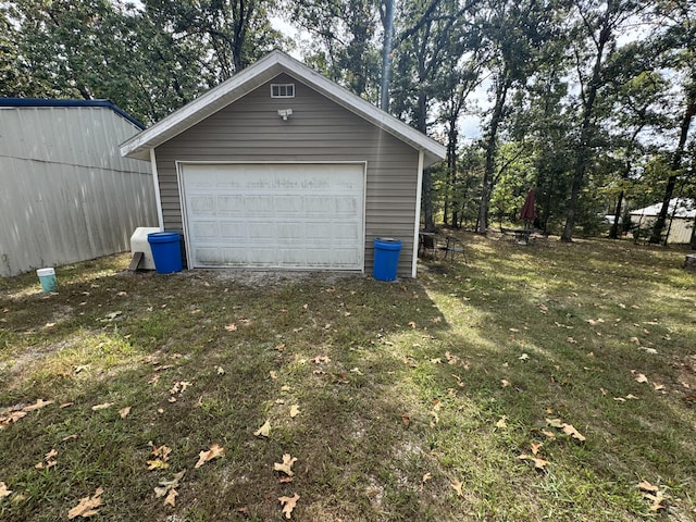 garage featuring a lawn