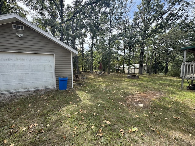 view of yard with a garage and an outdoor structure