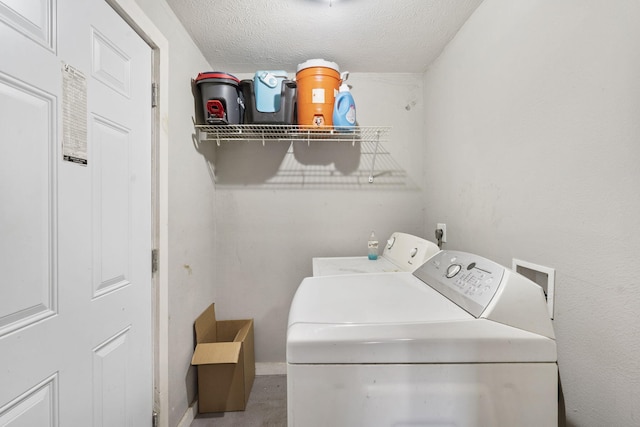 laundry area featuring washer and dryer and a textured ceiling