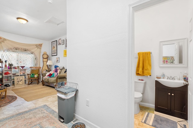 bathroom featuring toilet and vanity