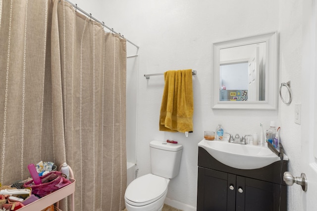 bathroom featuring toilet, vanity, and curtained shower